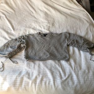 Gray ribbed cropped sweater with cinched sleeve